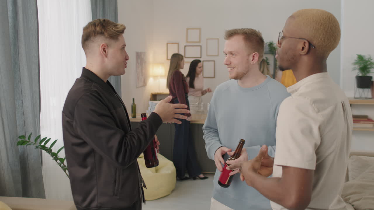 Three Young Men Chatting at House Party