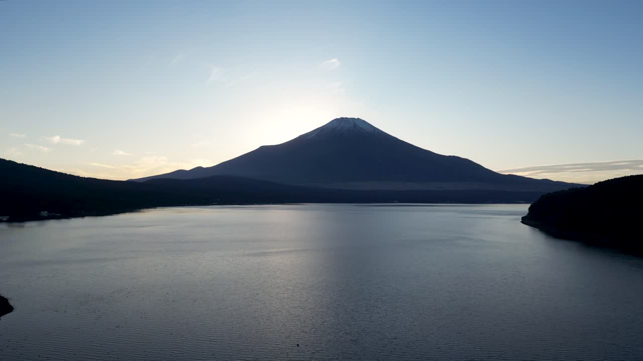 Beautiful cinematic drone flight over Mt. Fuji from above at sunset