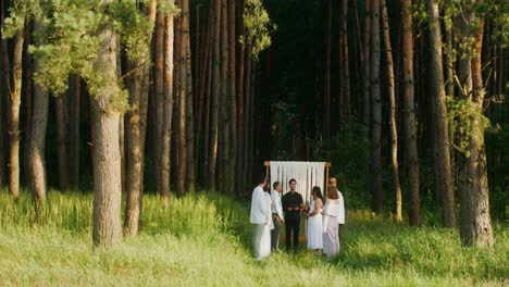 outdoor wedding ceremony in a pine forest