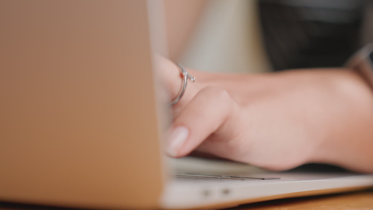 Woman using computer at desk. Woman is engaged in typing on her laptop at hotel reception desk. An elegant woman is diligently working on her portable computer situated at hotel reception area