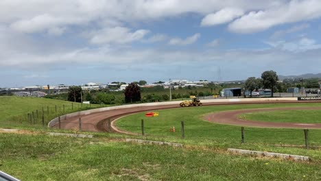 yellow-tractor-working-in-a-distance-on-the-racing-runway