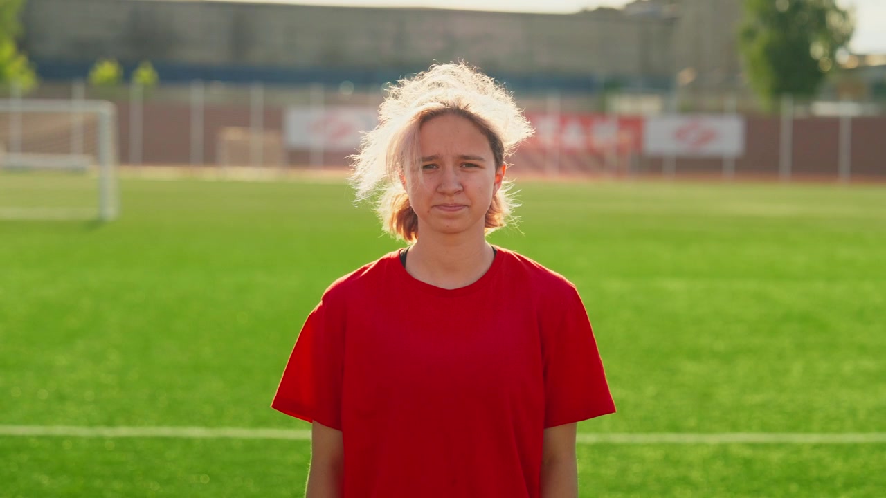 Young Female Soccer Player Standing on Field