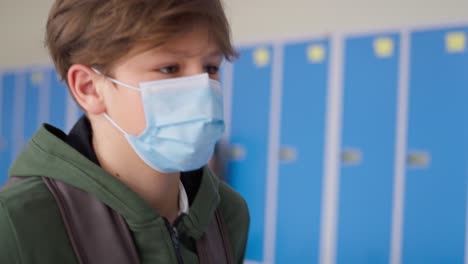 close up video of schoolboy in protective mask the corridor