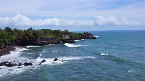 tanah lot temple and scenic seascape in bali, indonesia - aerial shot