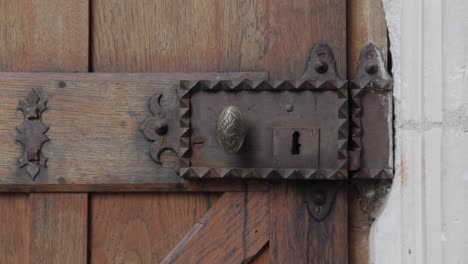 El-Viejo-Pomo-De-La-Puerta-De-Metal-En-La-Puerta-De-Madera-Está-Siendo-Sacudido