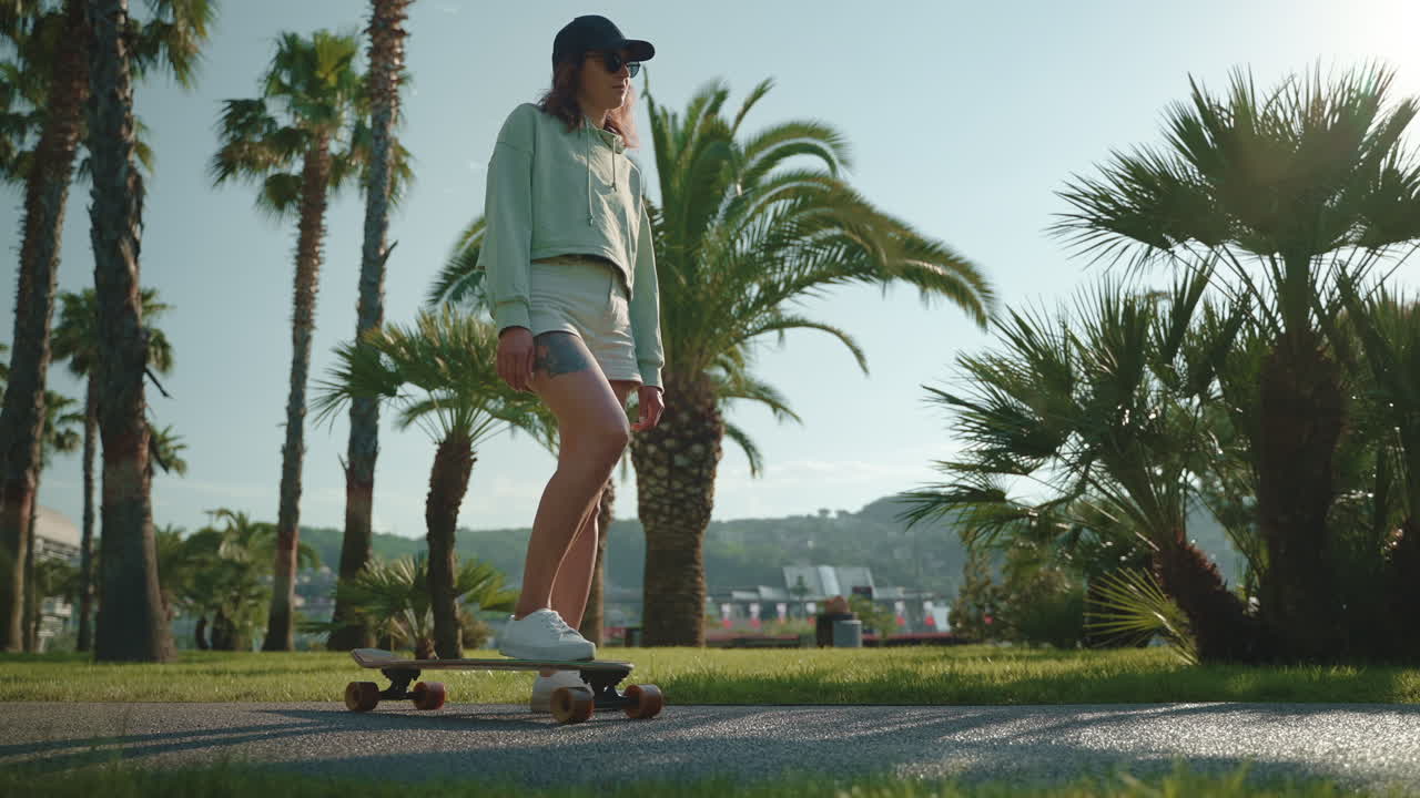 Woman Skateboarding in a Park on a Sunny Day
