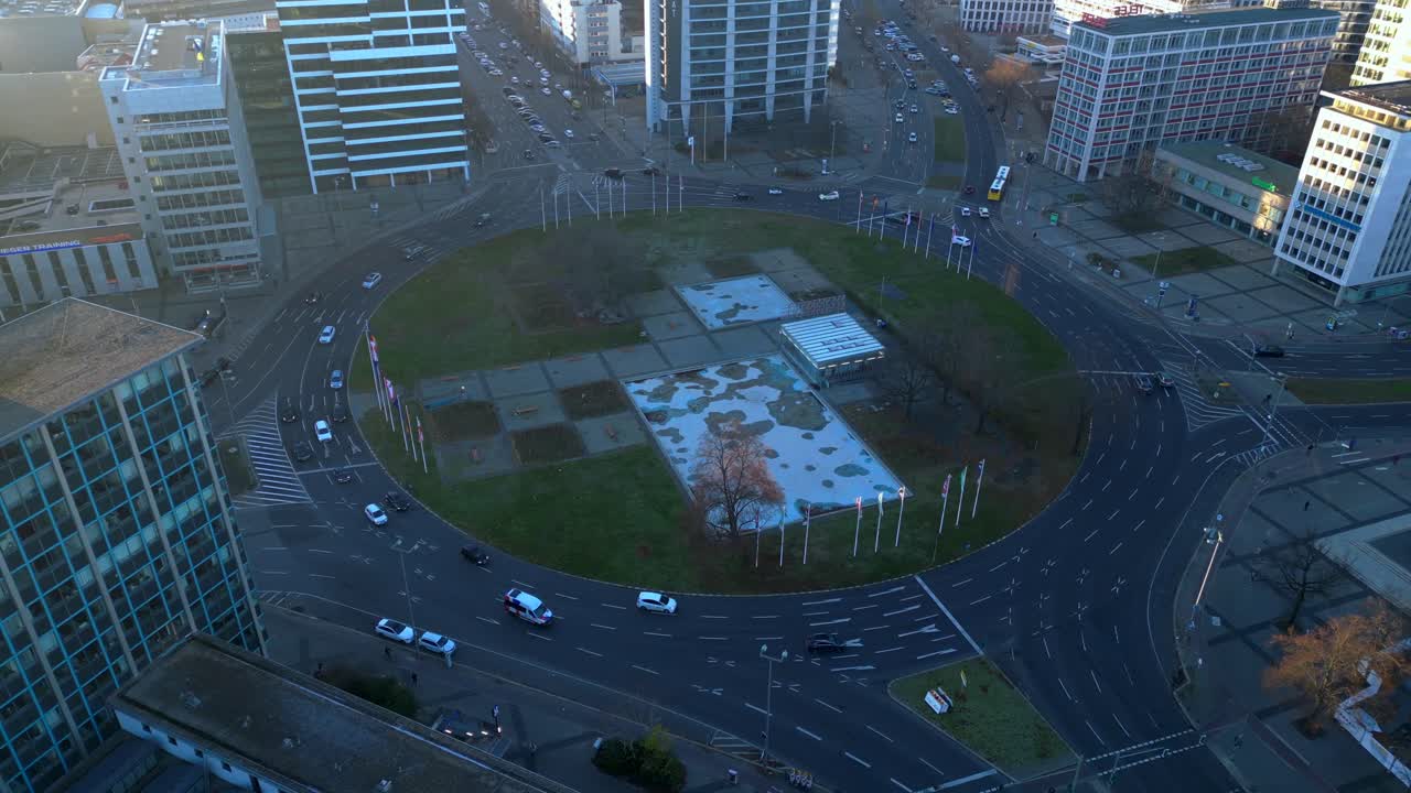 Cars driving around ernst reuter platz in berlin, germany during golden hour. Lovely aerial view flight panorama orbit drone