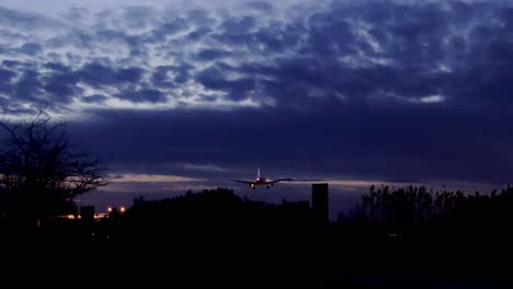 plane passing through the sky at night in barcelona