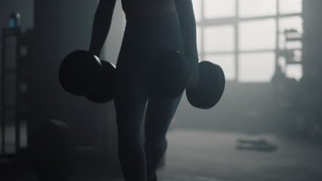 una chica fuerte entrenando con pesas en las manos. una mujer en forma haciendo sentadillas con estocadas