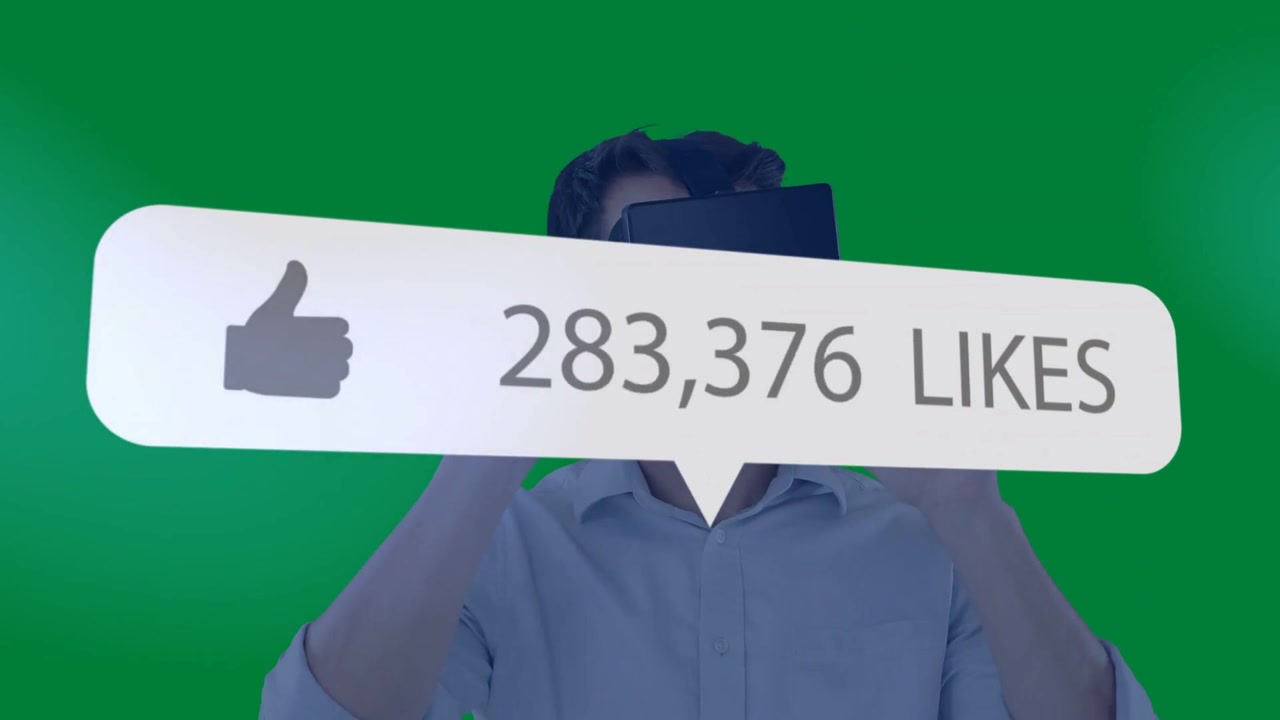 Adjusting VR headset, man in light button shirt watching rising like-count overlay on green screen