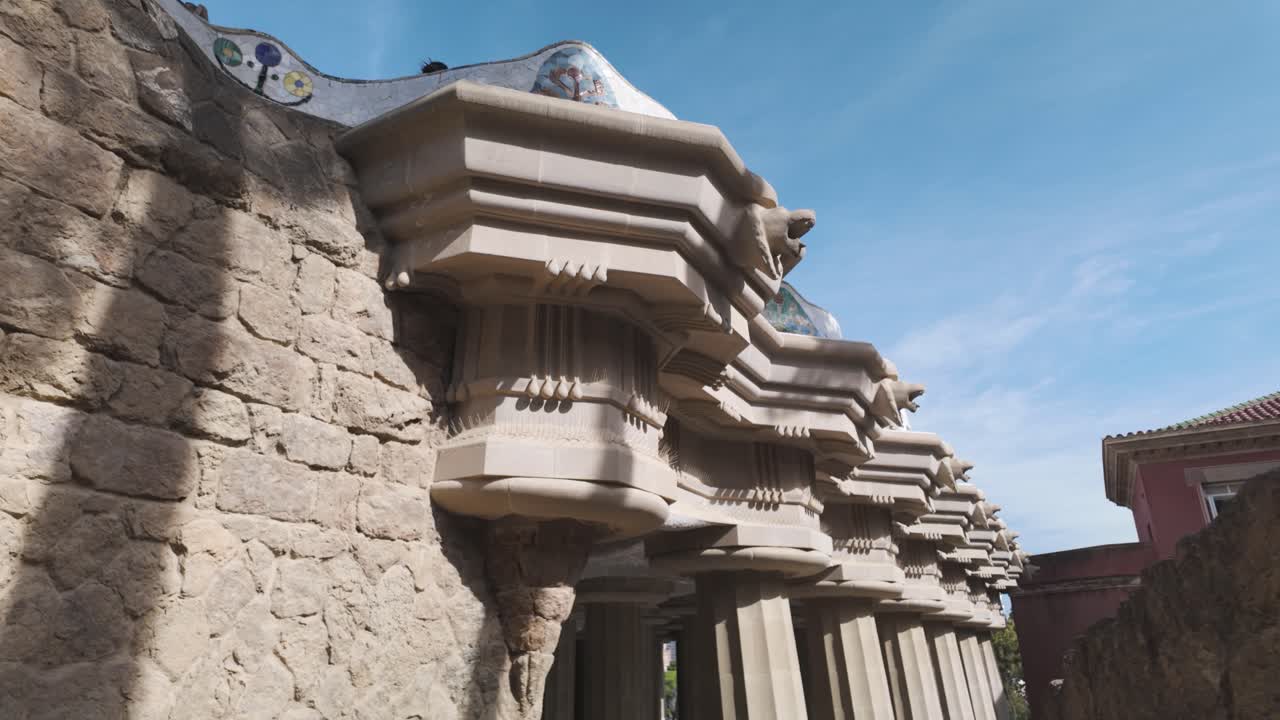 Architectural detail of the Hypostyle Room in Park Guell, showing the columns and the mosaic decorations on the ceiling