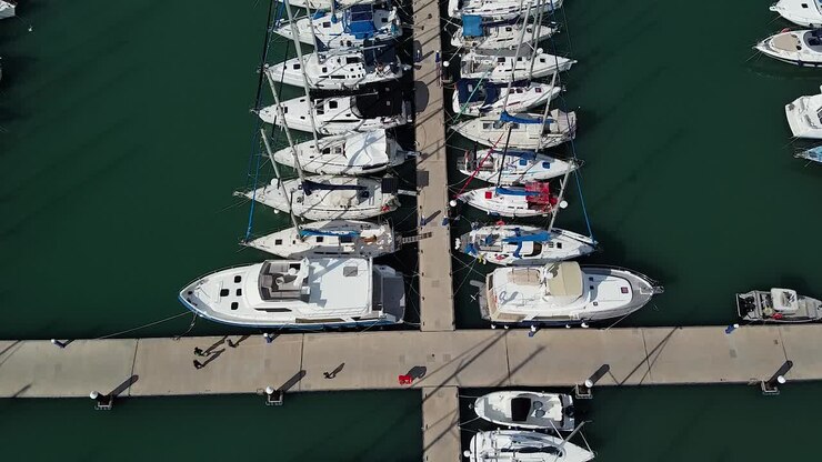 Aerial view of boats and yachts docked in a sunny marina
