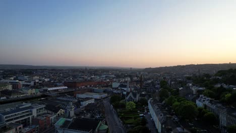 4K-Aerial-drone-crane-reveal-shot-of-the-city-of-Cork-at-sunset,-Ireland