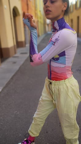 stylish woman in colorful printed bodysuit and joggers