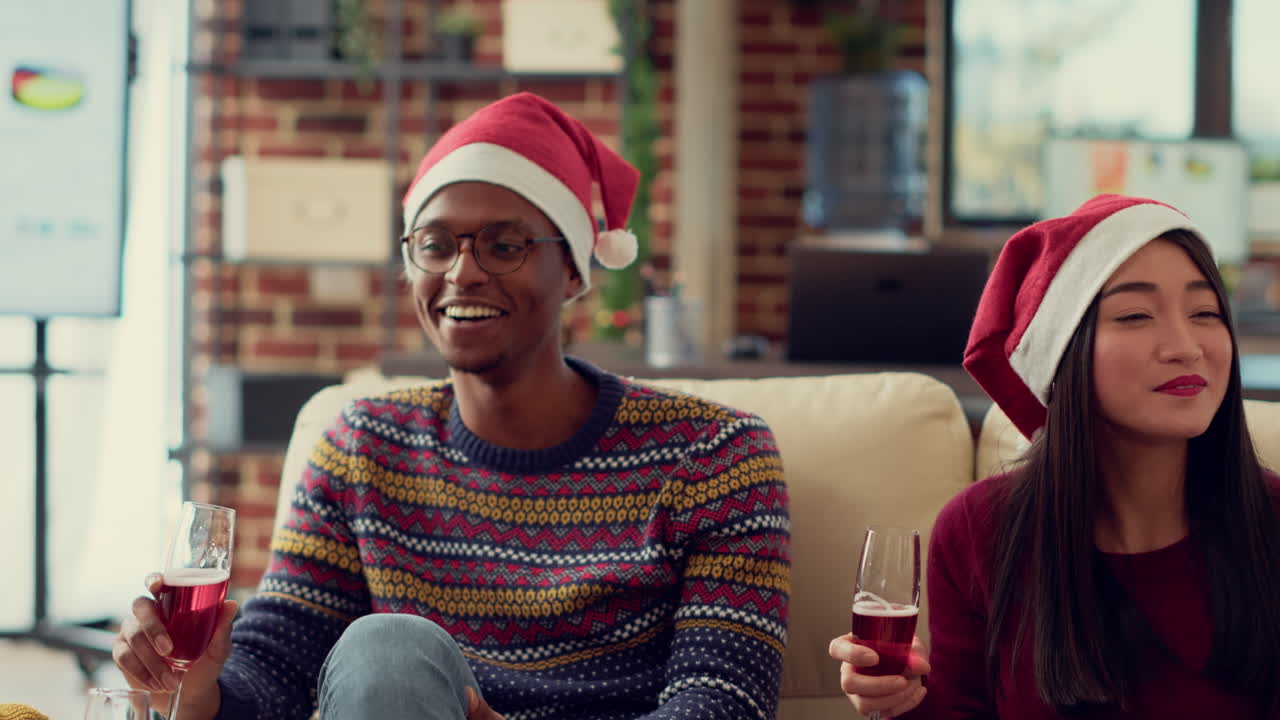 Diverse employees drinking glasses of wine at christmas party