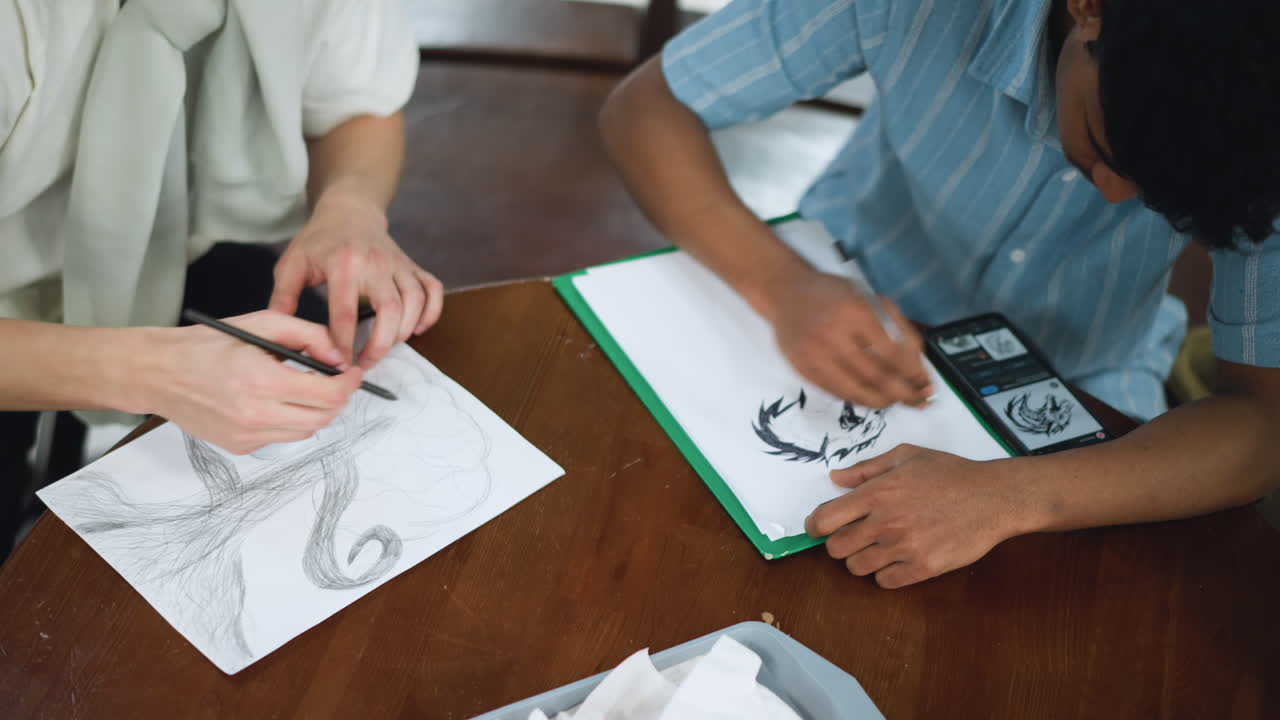 Closeup of hand sketching tree resembling mushroom trunk and canopy with ink strokes capturing organic curves shading depth forming on textured paper under soft light showing creative process unfold