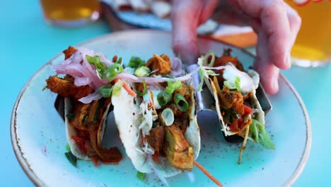 person eating tacos with beer in london