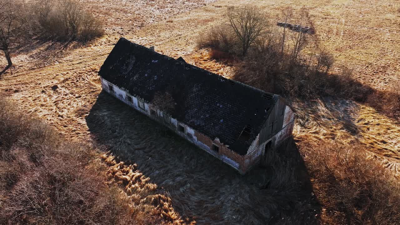 Abandoned countryside building filmed with drone in spring, metaphor of conflict