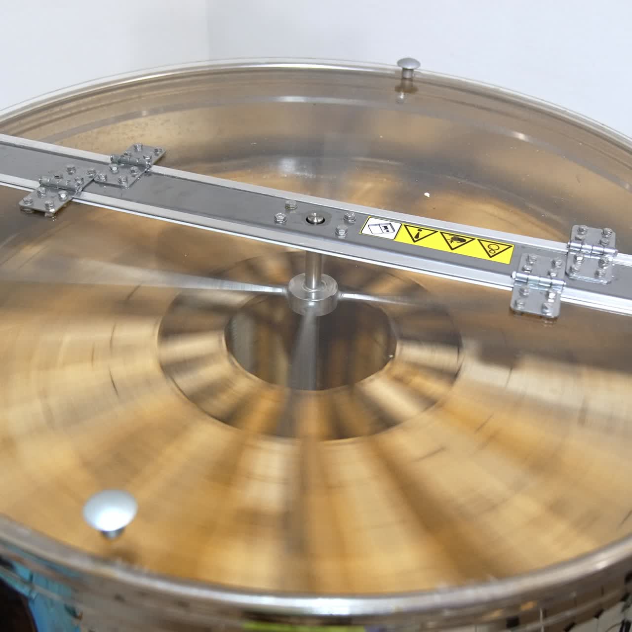 Sweet honey picking centrifugal harvest. Industrial honey making equipment