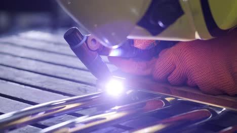 man wearing mask welding in a workshop. metal workers use manual labor. skilled welder. welder is welding the stainless steel pipes in the factory. welder industrial part in factory.