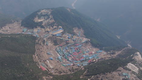 aerial shot of namche bazar, himalayan village nestled in lush green hills and forests on the way to mount everest in sagarmatha national park, nepal