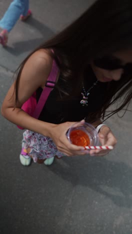 woman with drink on the street