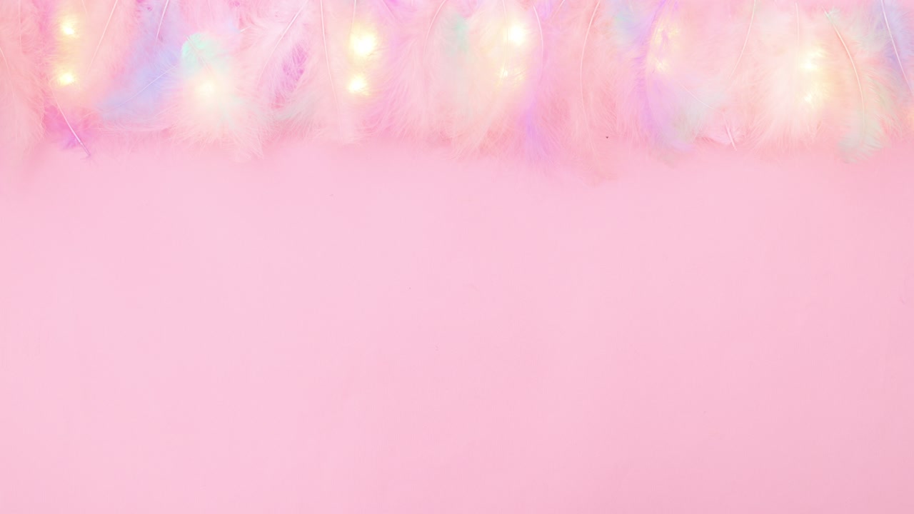 Pastel feathers and blinking lights on top of pastel pink theme. Stop motion