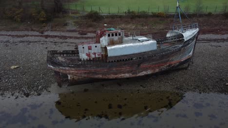 old boat of caol or corpach shipwreck on the shores of loch linnhe - fort william, scotland