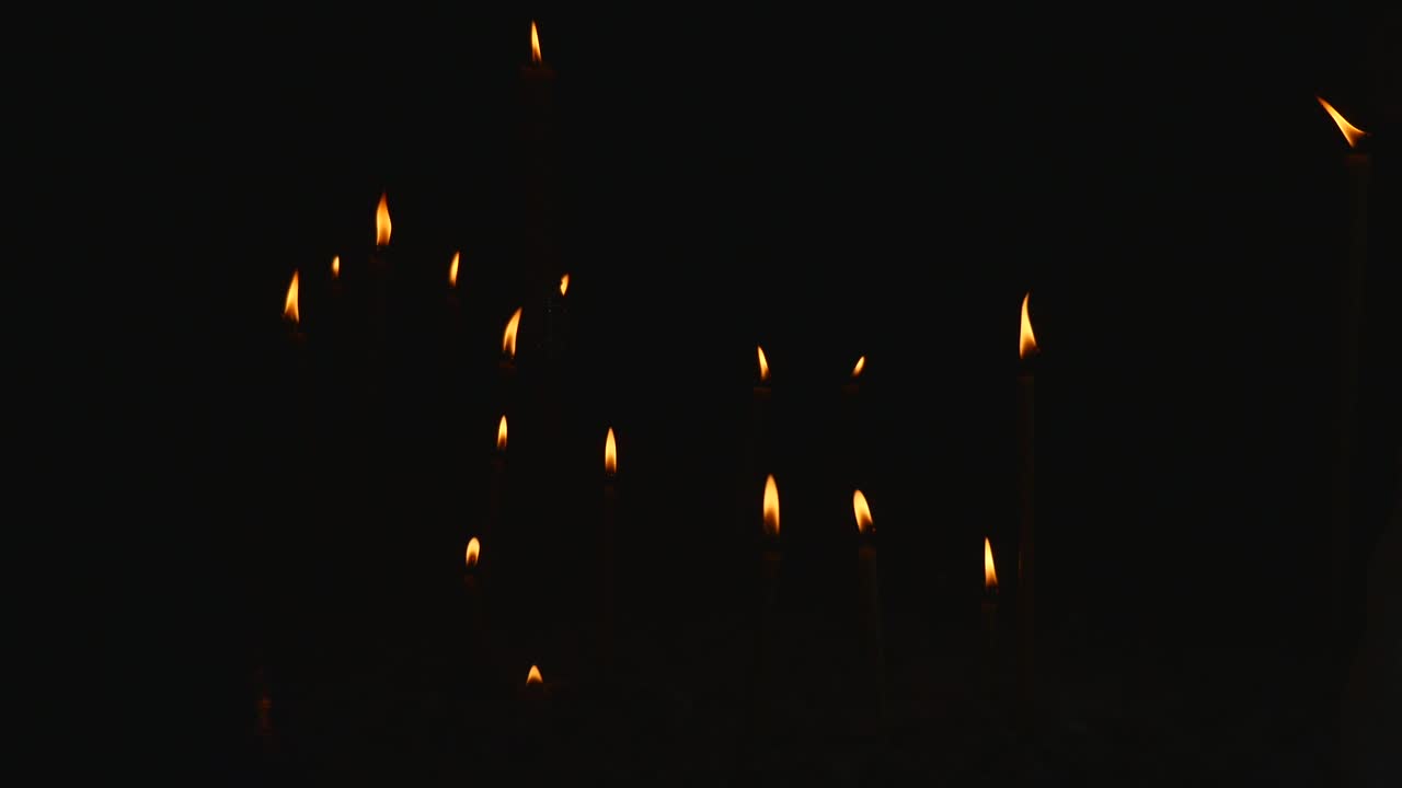 Several Candles lined up over Black Background