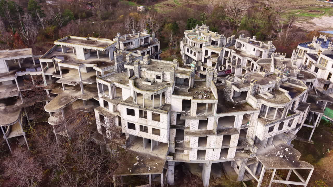 Urban decay unveils haunting beauty in abandoned structures nestled in nature's embrace