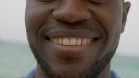 close-up of african american man standing on the beach 4k