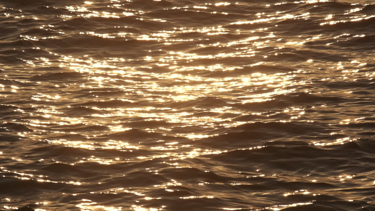 Slow motion sea surface at sunset