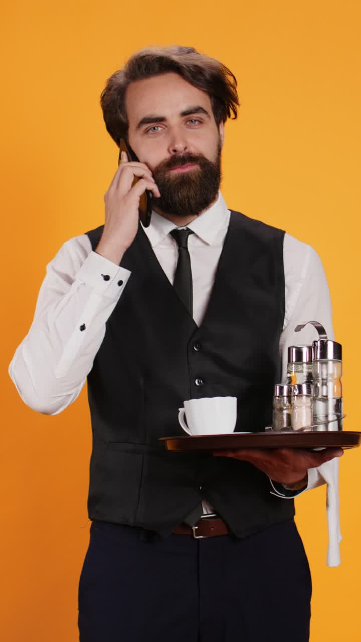 Vertical video Professional butler answering phone call