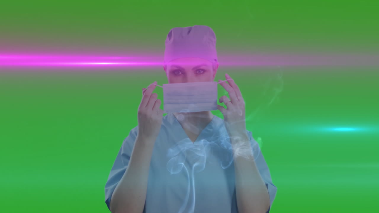 Medical provider adjusting surgical mask in green screen studio, showcasing light flares and smoke