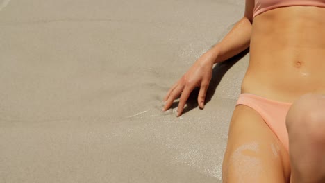 mid section of woman relaxing on the beach 4k