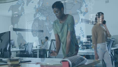 animation of circuit board pattern on map over african american woman analyzing report on desk