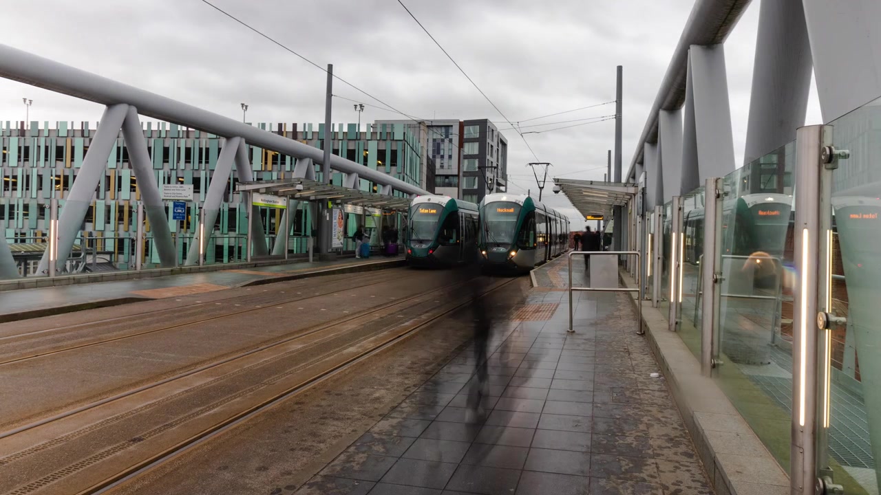 Nottingham, Inghilterra: Timelapse del tram NET alla fermata della stazione con pendolari indaffarati