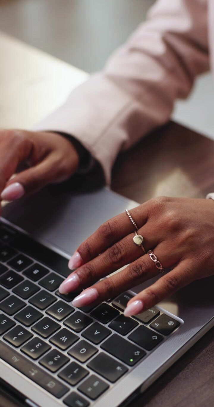 Close-up of Woman Typing on Laptop Keyboard