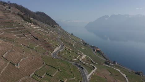 Aerial-of-long-road-running-trough-beautiful-countrysidewit-a-single-cyclist-cycling-in-the-distance