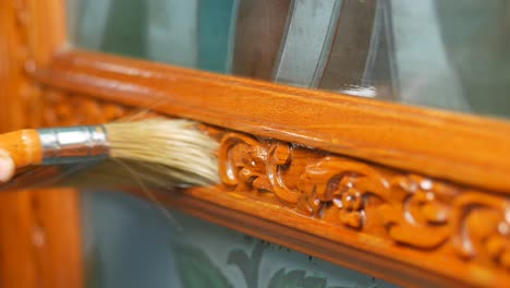 polishing wooden frame with carvings