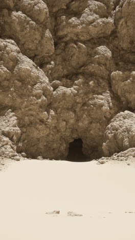 a cave entrance in a desert landscape