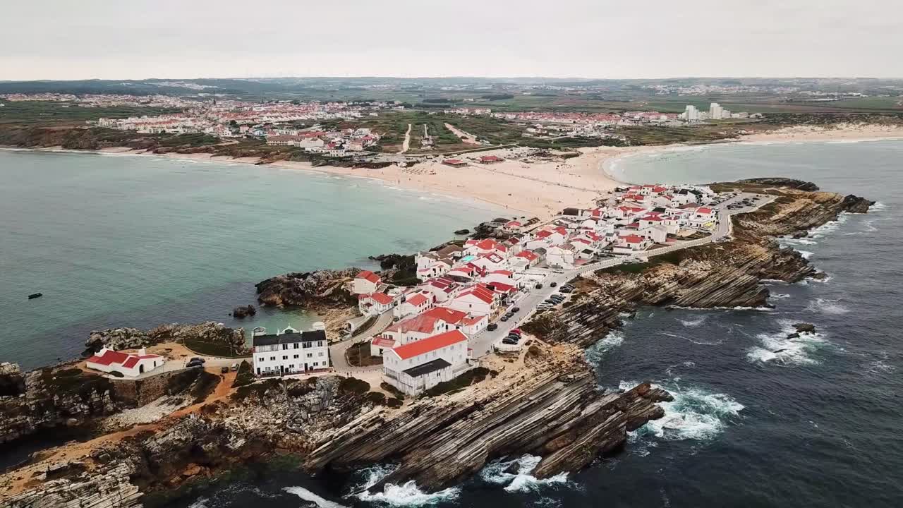 Baleal, Portugal, features a picturesque coastal village with iconic red roofed houses, rugged cliffs, and serene ocean view. Location highlights sandy beaches and unique rock formations