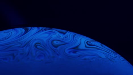 mesmerizing abstract macro shot of blue flowy lines from liquid solution