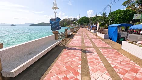 peaceful seaside walkway at panwa beach in phuket, thailand