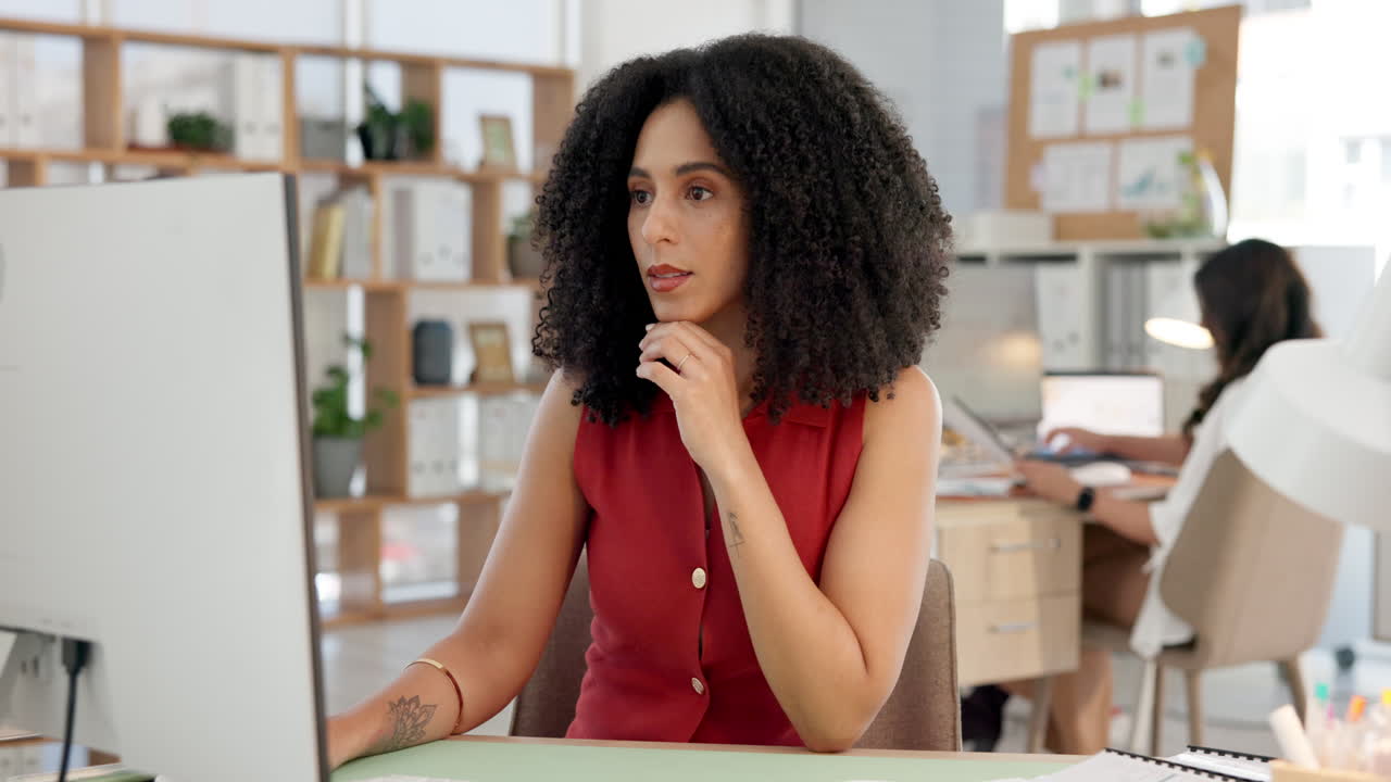 Focused Woman Working on Computer at Her Desk in a Modern Office
