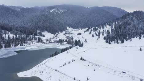 Snowy-mountain-landscape.-Aerial-descending-approach