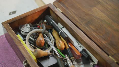 close up of box full of tools in leather workshop