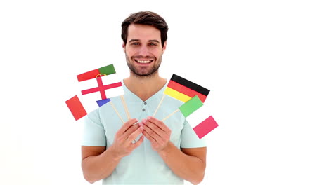 handsome young man showing flags