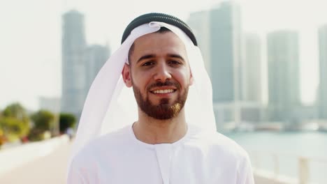 smiling man in traditional arab clothing