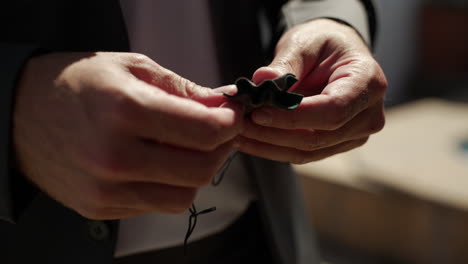 ring barer opening the pouch that holds the silver wedding ring